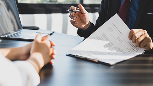 person and lawyer looking at paperwork