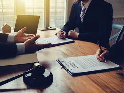 People sitting at a table with paperwork
